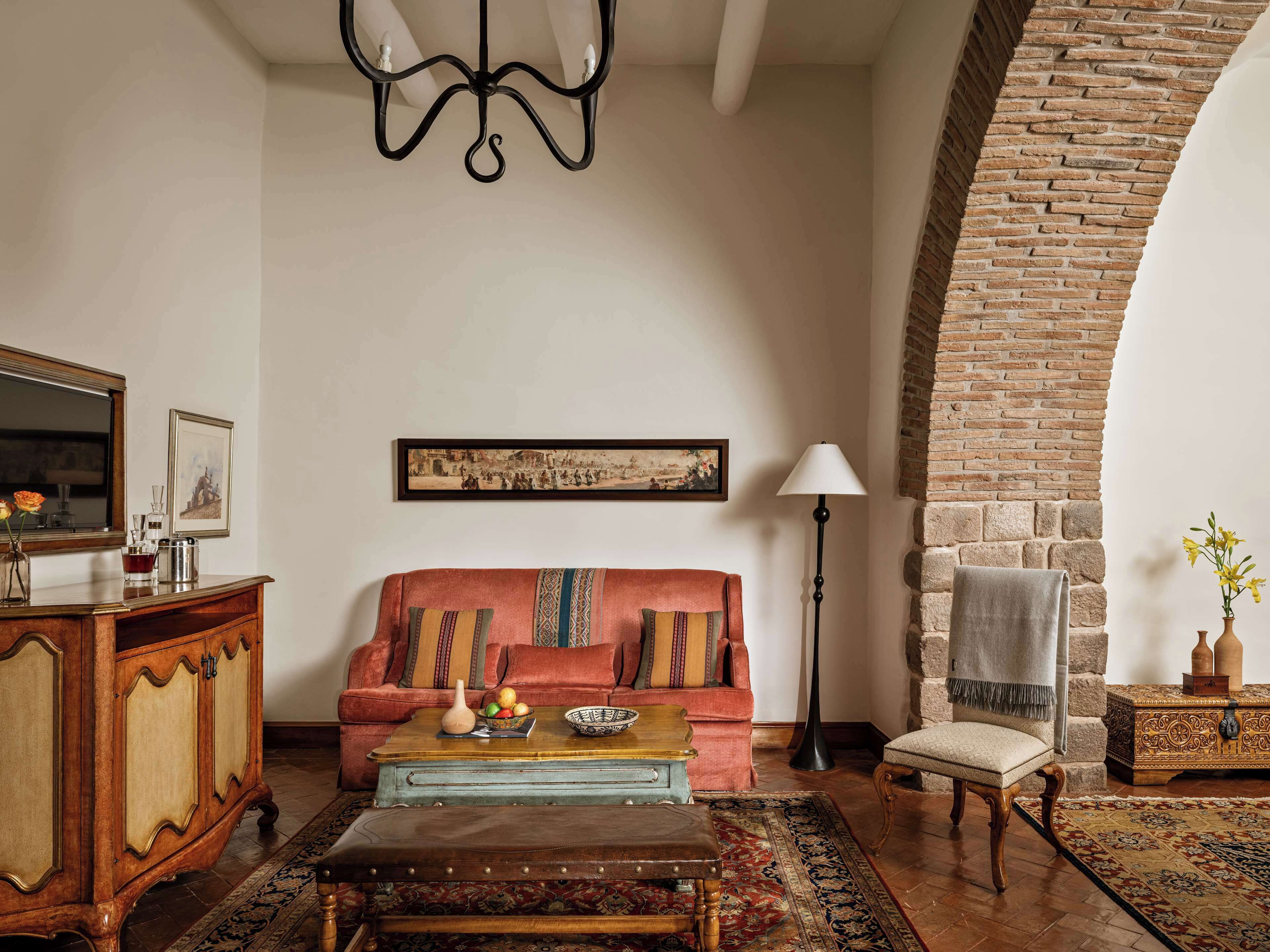 A living room with a sofa, coffee table, and a chandelier.