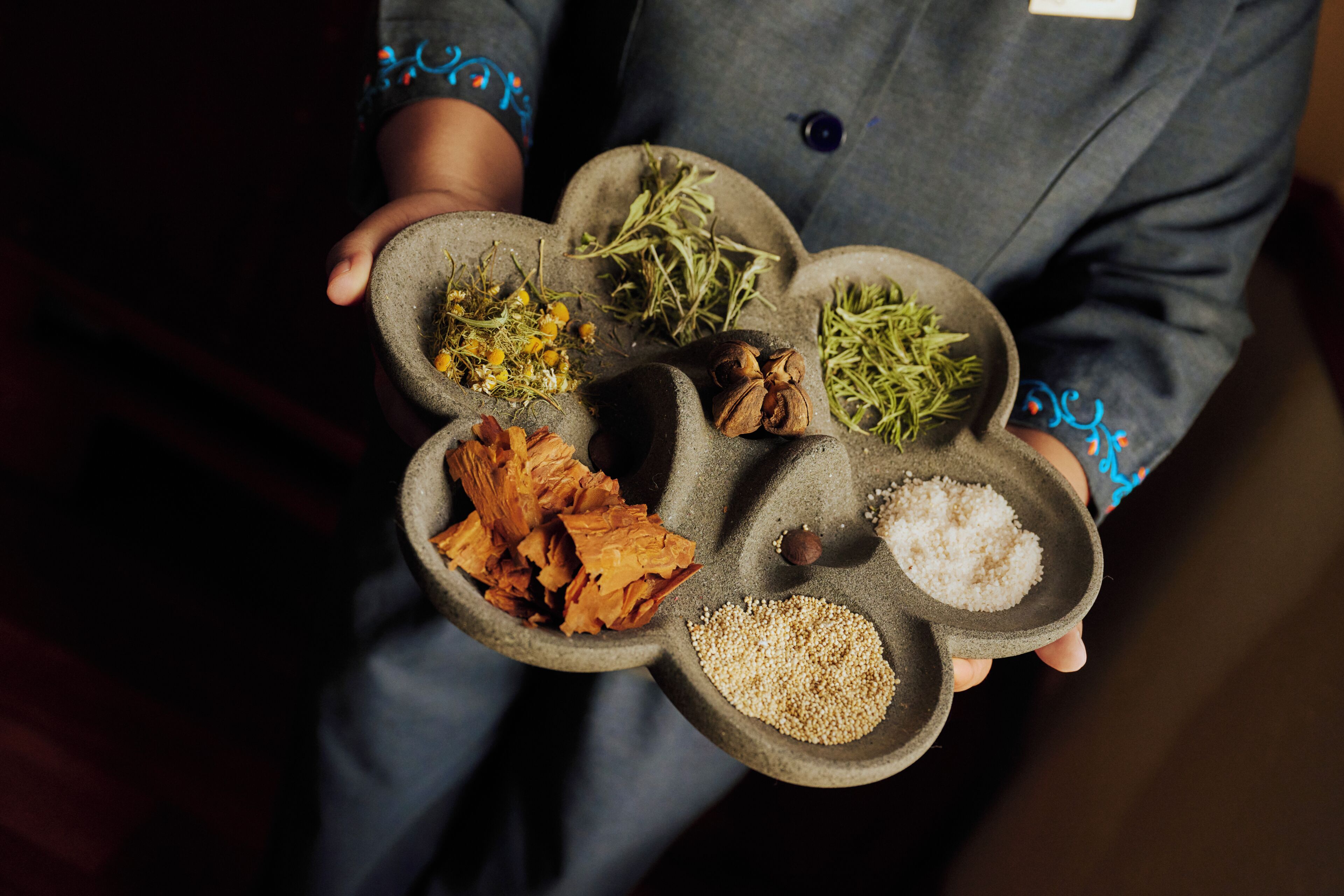 A person holding a tray with various food items.
