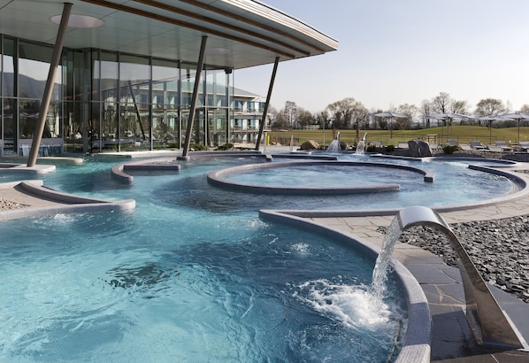 Relax by the pool with lounge chairs and umbrellas in a dynamic outdoor space.