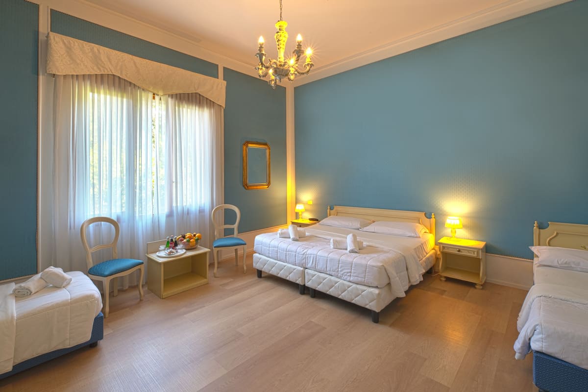 Superior Triple Room | Minibar, in-room safe, desk, laptop workspace