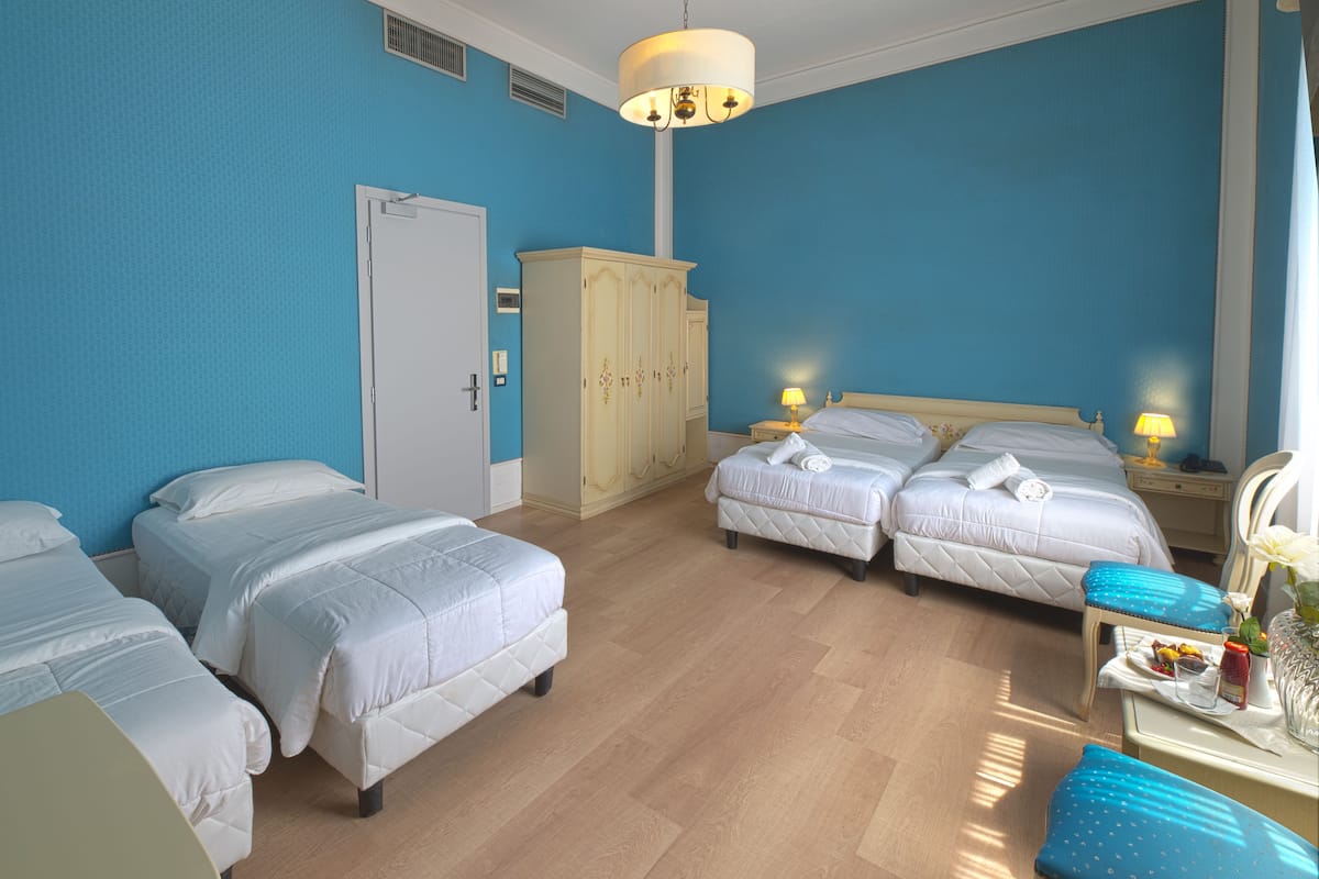 Superior Quadruple Room | Minibar, in-room safe, desk, laptop workspace
