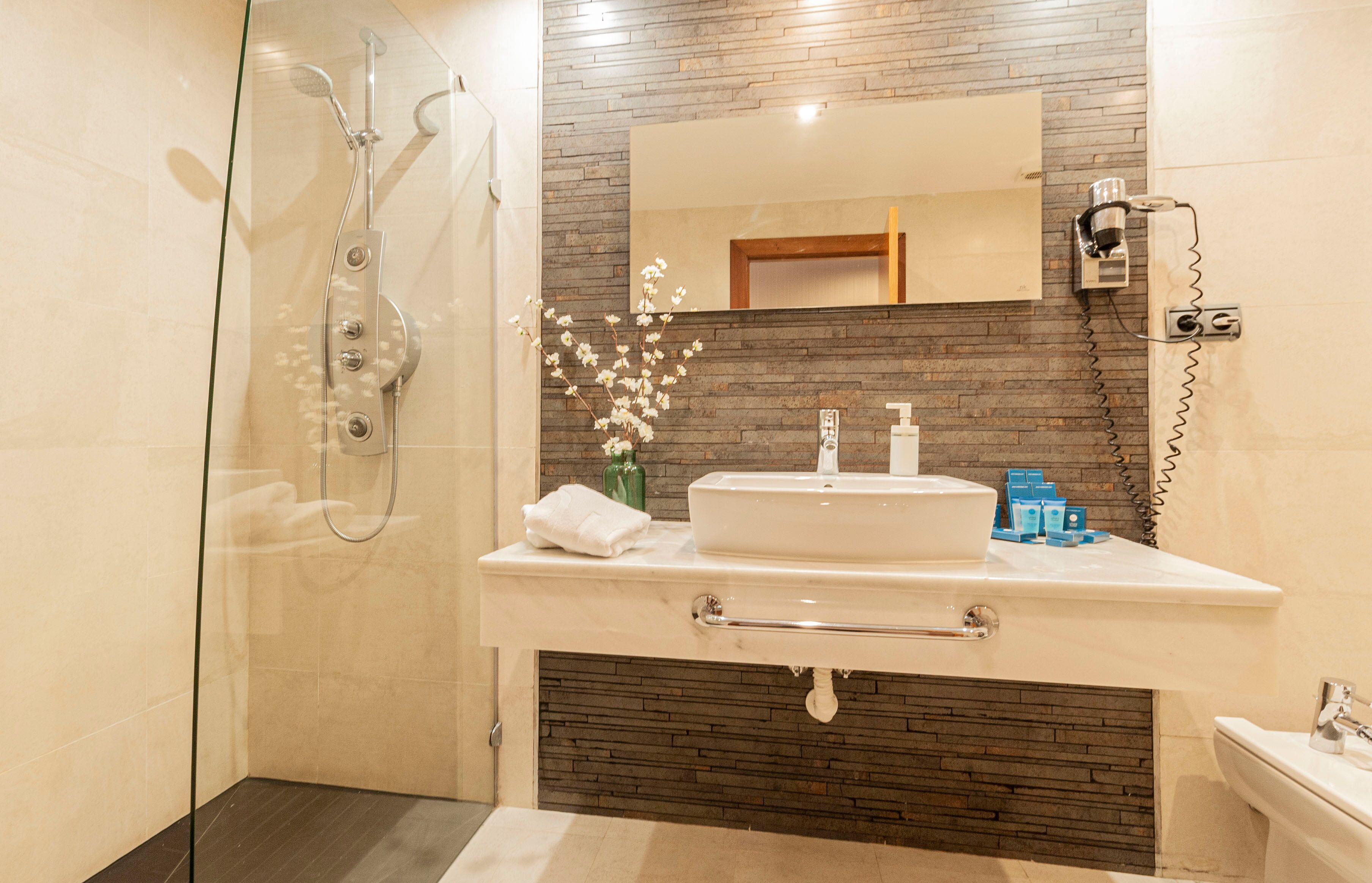 superior double room | bathroom | shower, free toiletries, hair dryer, towels