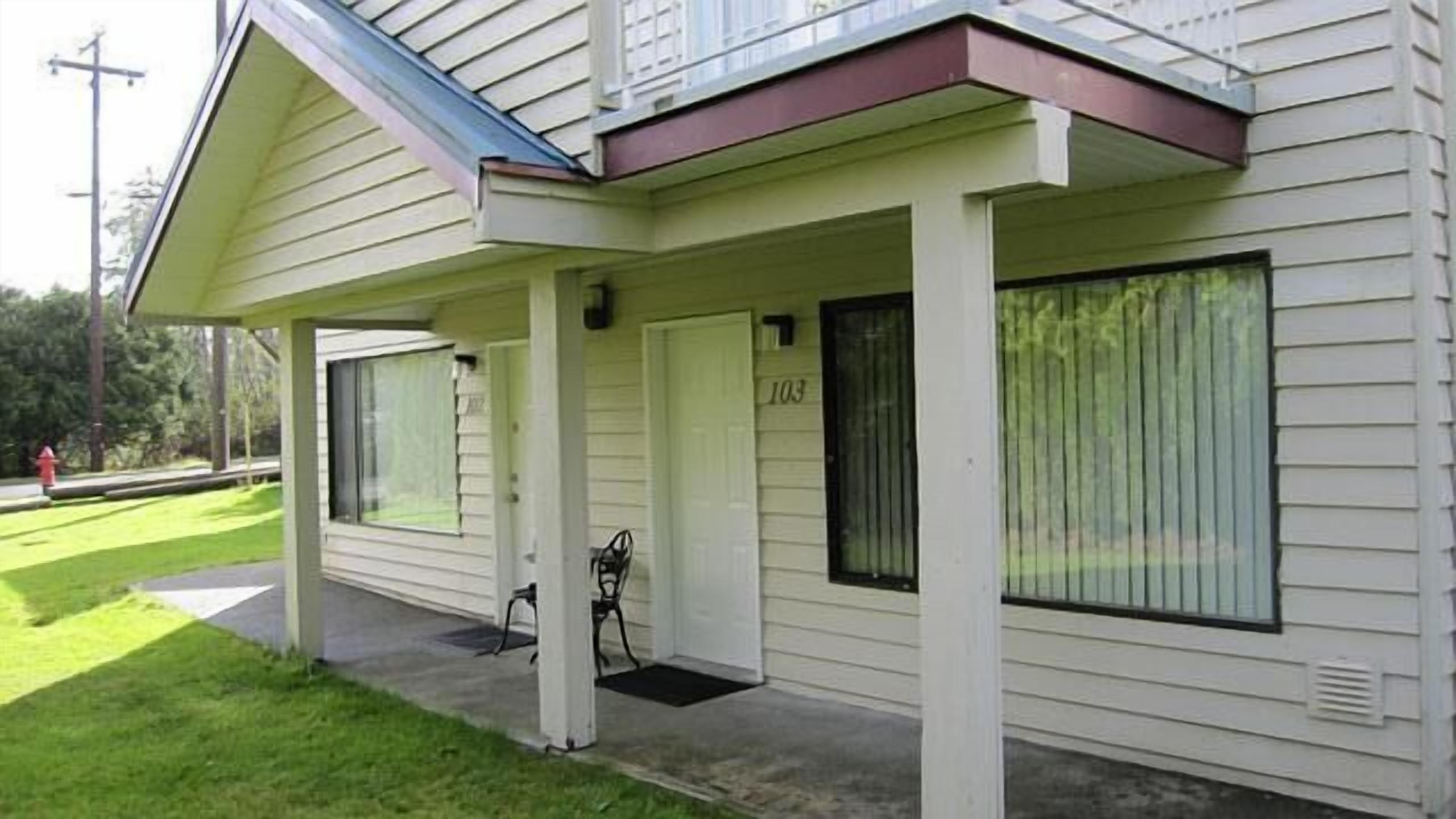 A single-story house with a covered porch, a door labeled "103", and a window with a screen.