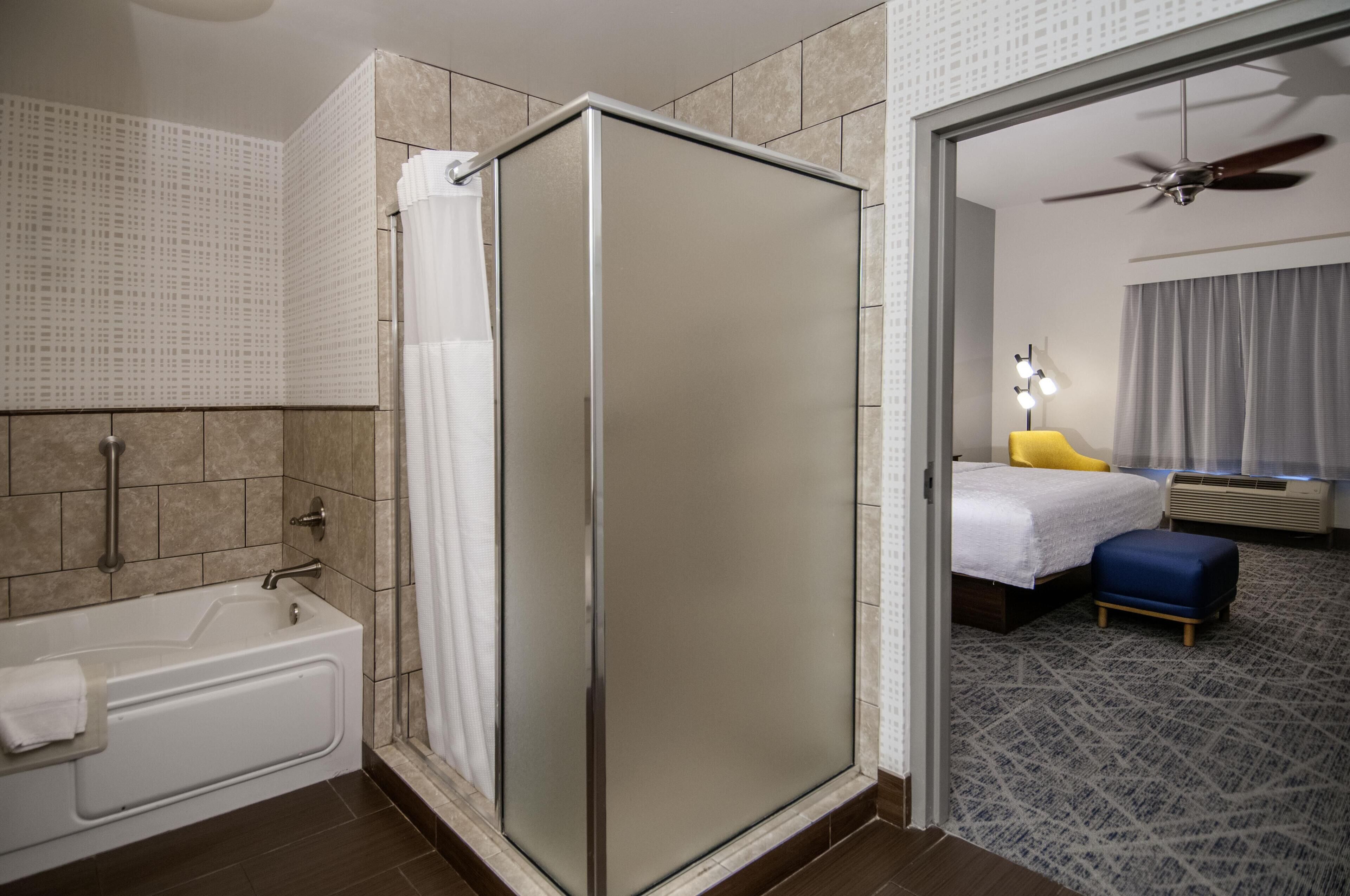 Suite, 1 King Bed, Non Smoking | Bathroom | Shower, free toiletries, hair dryer, towels