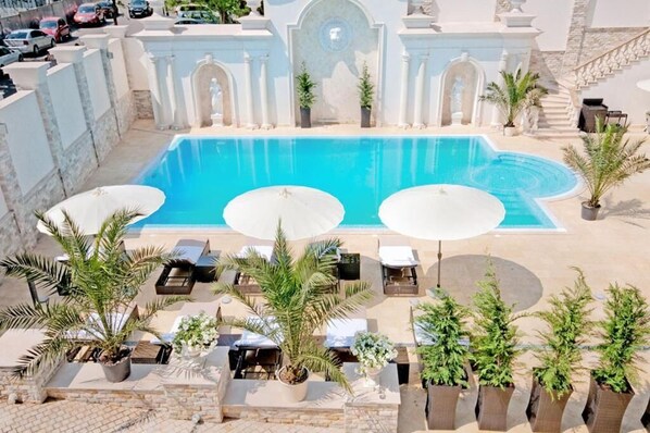 A pool area with three sun loungers and a large pool. - Villa Le Premier - Maestro (Odesa)