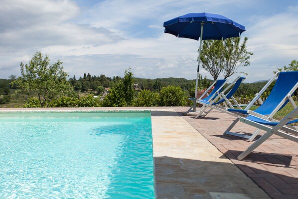 室外游泳池，池畔遮阳伞，日光浴躺椅