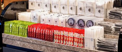 A display of various packaged goods, including what appears to be toiletries and personal care items, neatly arranged on shelves.