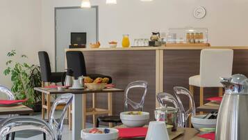 A modern breakfast area with a counter, seating, and various breakfast items.