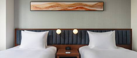 A hotel room with two beds, a nightstand with a clock and a control panel, and a wall-mounted abstract painting.