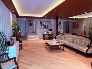 A spacious living area with a sofa, coffee table, and a staircase leading to an upper floor. - Residence L'heritage Hipólito Taine by Bluebay (Mexico City)