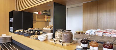 A breakfast buffet with various food items and condiments.