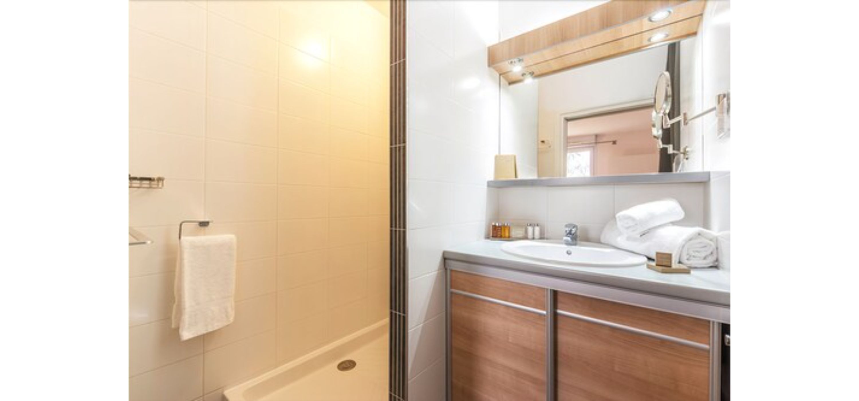 A modern bathroom with a shower, a sink, and a mirror.