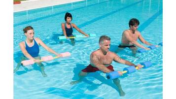 Una piscina techada, sillones reclinables de piscina