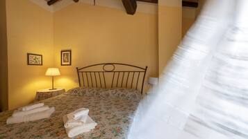 Un dormitorio con una cama, dos lámparas de noche y una mesita de noche con lámpara.