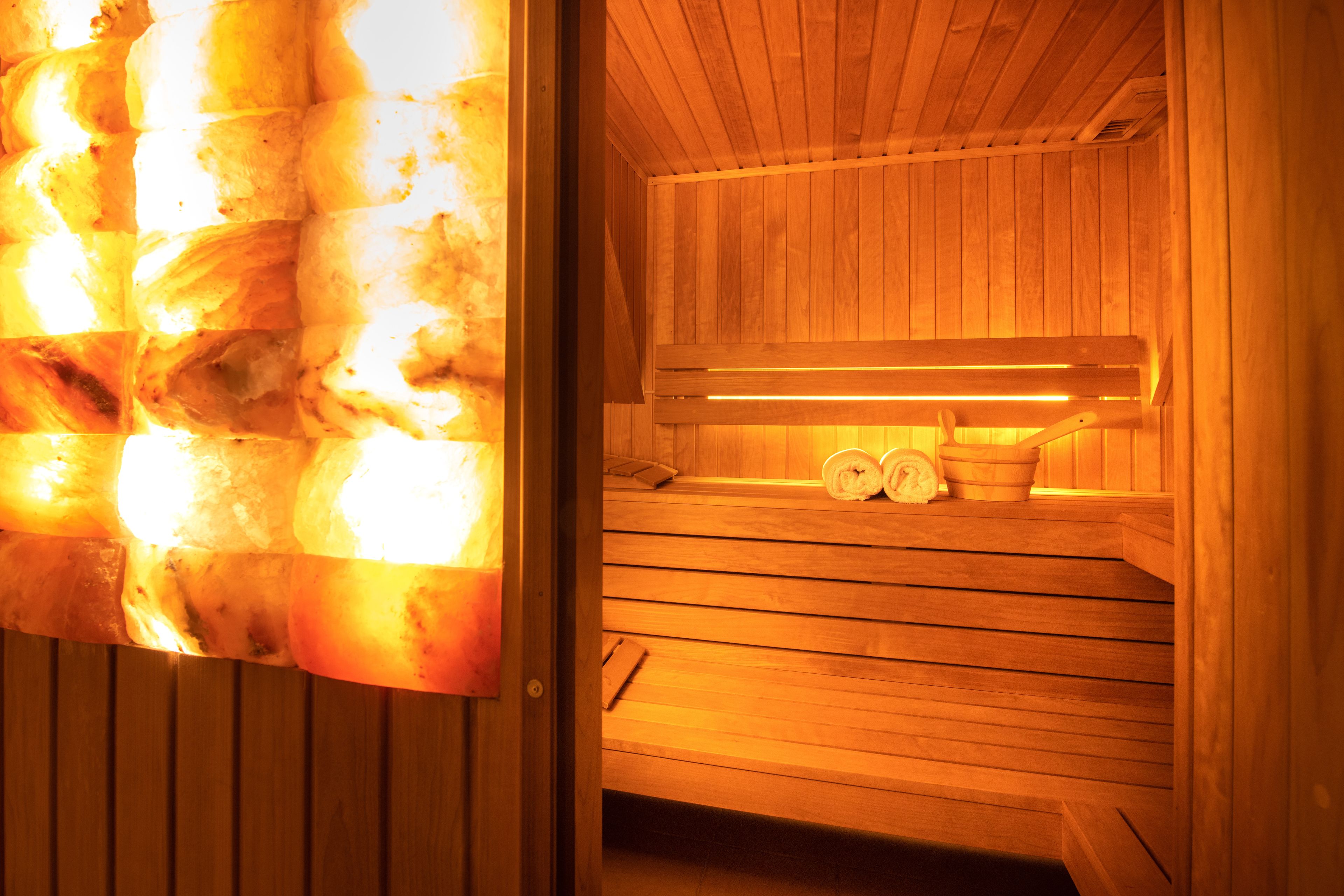 A sauna with wooden benches and a bench heater.
