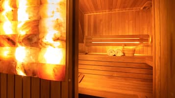 A sauna with wooden benches and a bench heater.