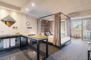 A modern hotel room with a bed, a bathroom with a sink and mirror, a small table, and a view of the outside. - Prodeo Hotel & Lounge (Buenos Aires)