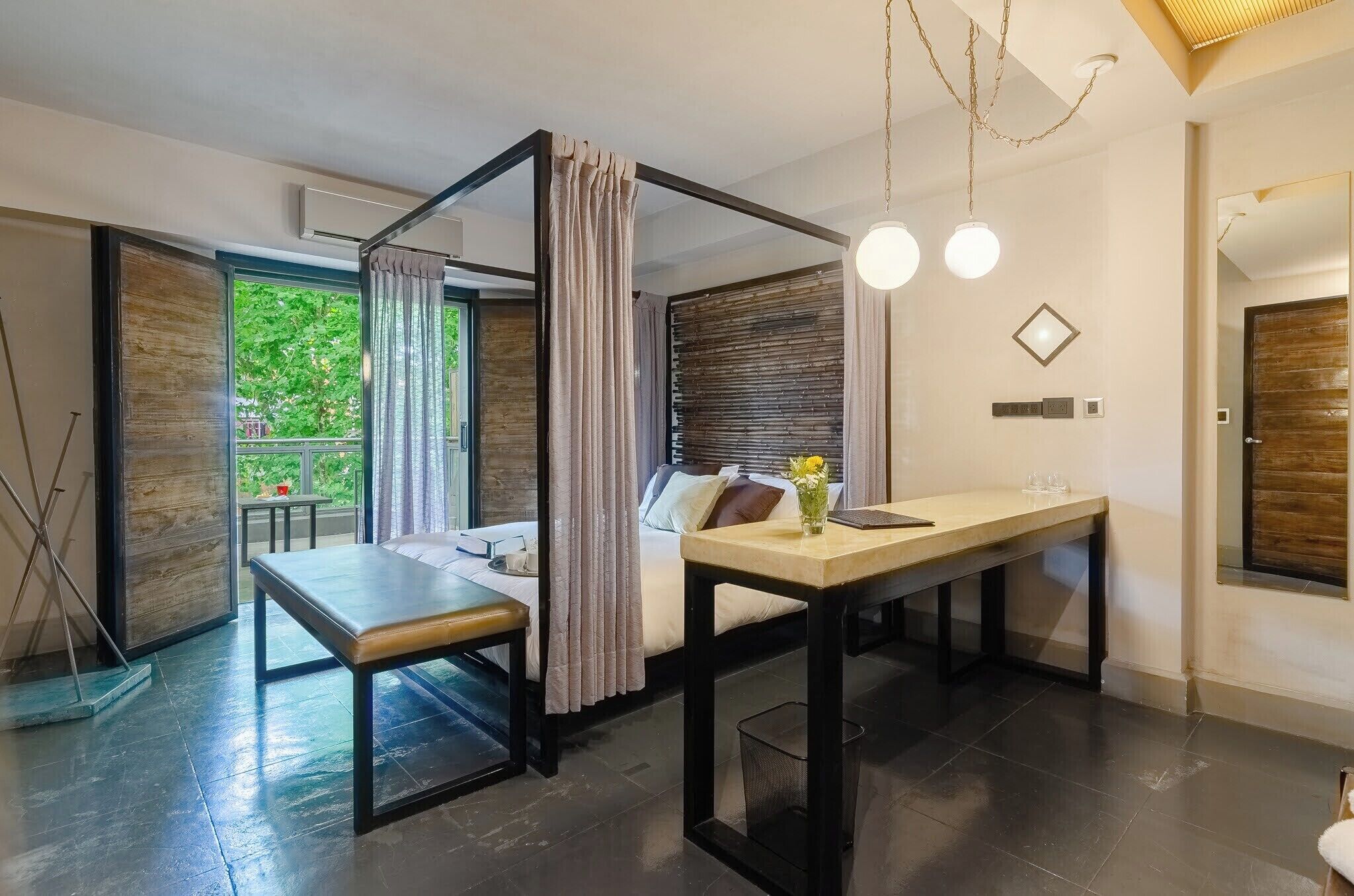 A modern room with a bed, a desk, a chair, and a window with curtains.