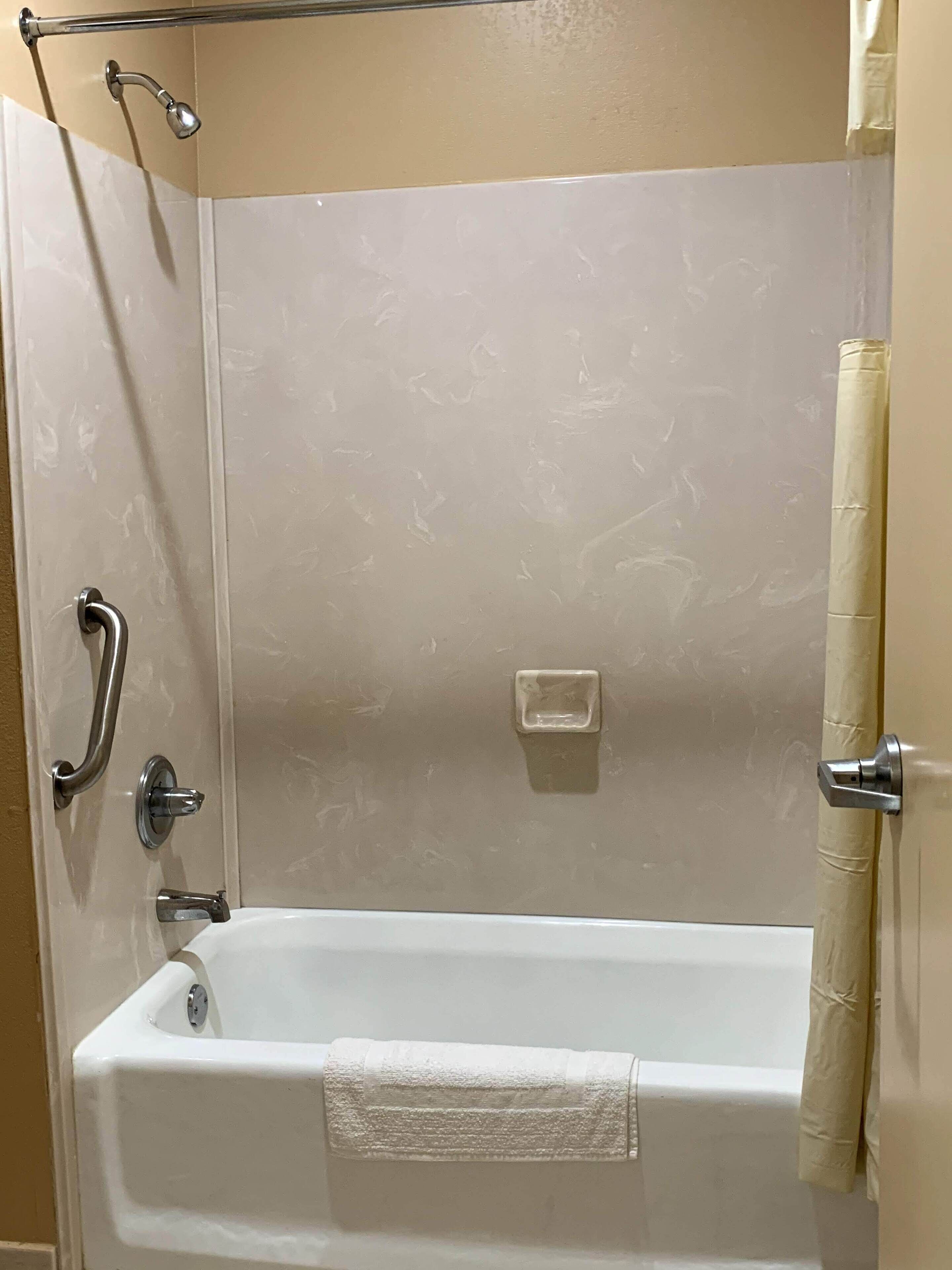 A bathroom with a bathtub, a shower, and a toilet.