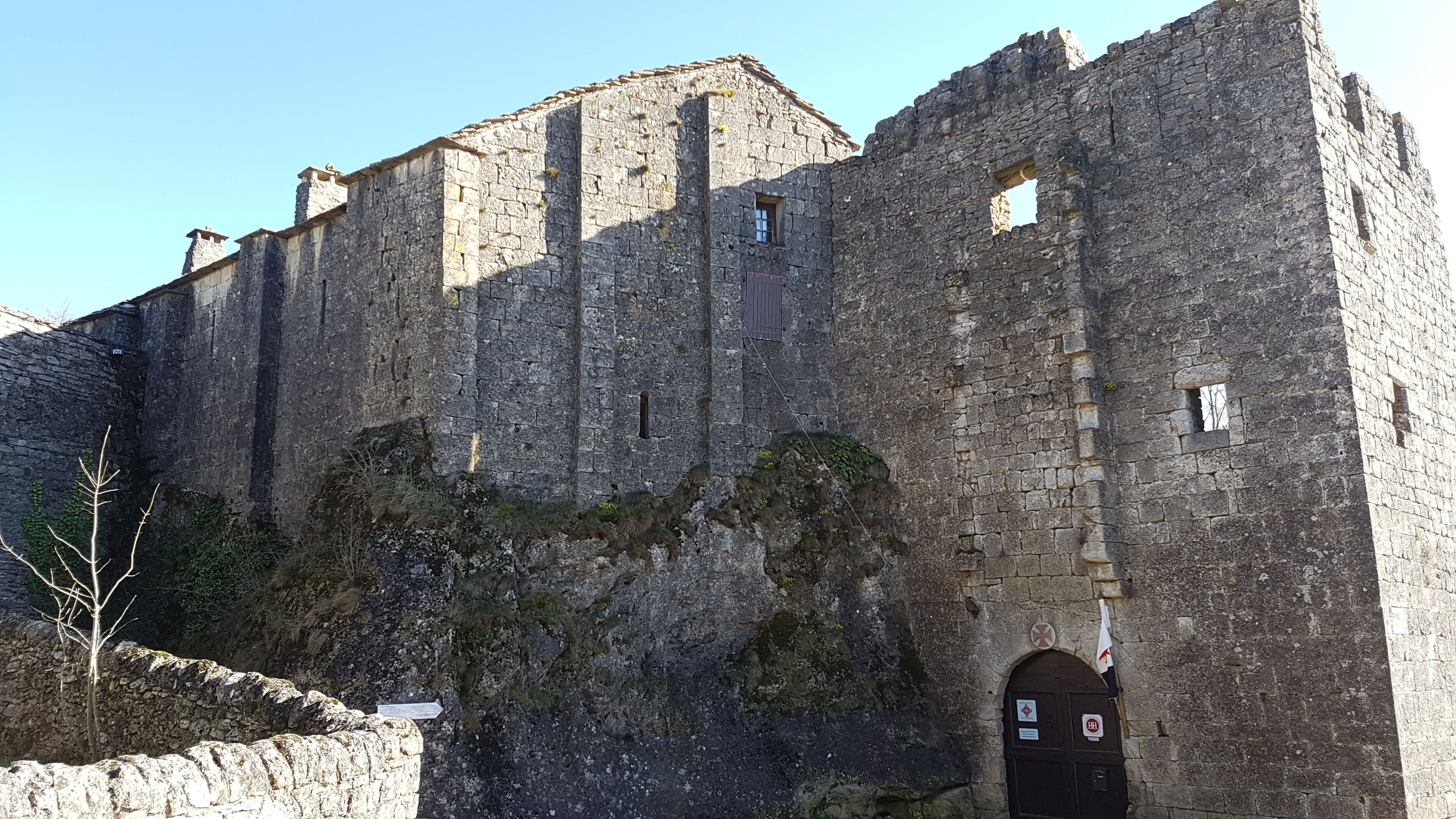 A stone castle with multiple towers and a large arched entrance.