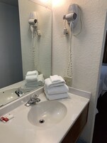 Desk, laptop workspace, blackout drapes, iron/ironing board