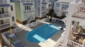 A multi-story hotel with a central swimming pool surrounded by balconies and outdoor seating areas. - Ocean Views!102 West Terminal Blvd Unit #15 Atlantic Beach, NC (Atlantic Beach)