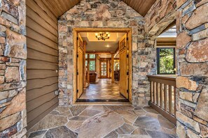 A stone-walled hallway with a wooden door leading to a room with a view. - Hot Tub, Game Room, Near Heavenly Ski Resort. (South Lake Tahoe)