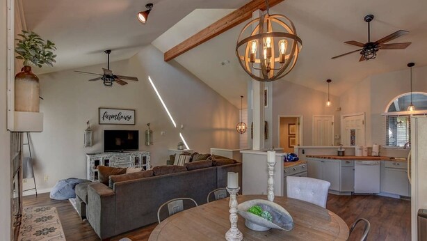 A spacious living area with a high ceiling, exposed beams, a central chandelier, and a cozy seating arrangement. - Close to Prescott Square,2 Pools,Playground,Tennis,Pickle Ball,Trails,Wildlife (Prescott)