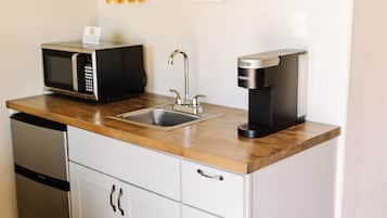 Fridge, microwave, coffee/tea maker, cookware/dishes/utensils