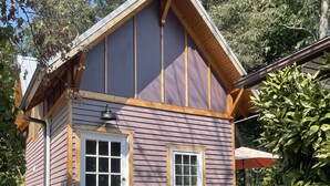 A small, single-story house with a front porch, a white door, and a window. - Beautiful Asheville Tiny Home Get-a-way (Asheville)
