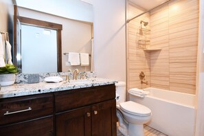 Combined shower/bathtub, hair dryer, towels, soap