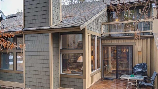 A modern house with a large deck, a covered patio, and a visible staircase leading to an upper level. - Near Marina, stables, great location sleeps 8 (Sunriver)