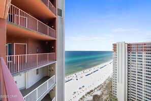 A high-rise building with balconies overlooking a beach. - 2128 Pool & Beach views,  w/ two parking passes, spectacular lagoon-style pool (Panama City Beach)