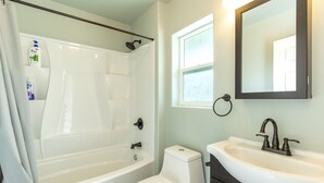 Une salle de bain avec une baignoire, des toilettes et un lavabo.