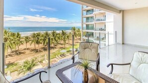 A balcony with a view of the beach and ocean. - Diamante sol 502S Dual Master Steps min walk 2 town (Jaco)
