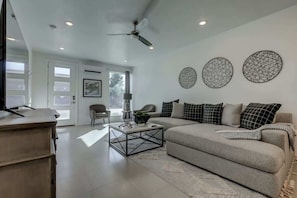 A modern living room with a sofa, coffee table, and decorative wall art.