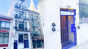 A building with a blue gate and a sign for Pacific Tradewinds.