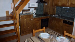 A compact kitchen with wooden cabinets, a microwave, a coffee maker, and a sink. - Superb 2 room apartment (1 bedroom) + mezzanine ...... at the foot of the slopes! (Lanslevillard)