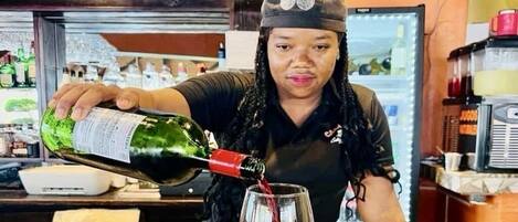 A person pouring a drink into a glass.