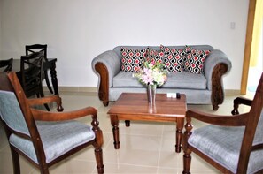 Relax in this inviting living room with a sofa, two armchairs, and a coffee table.