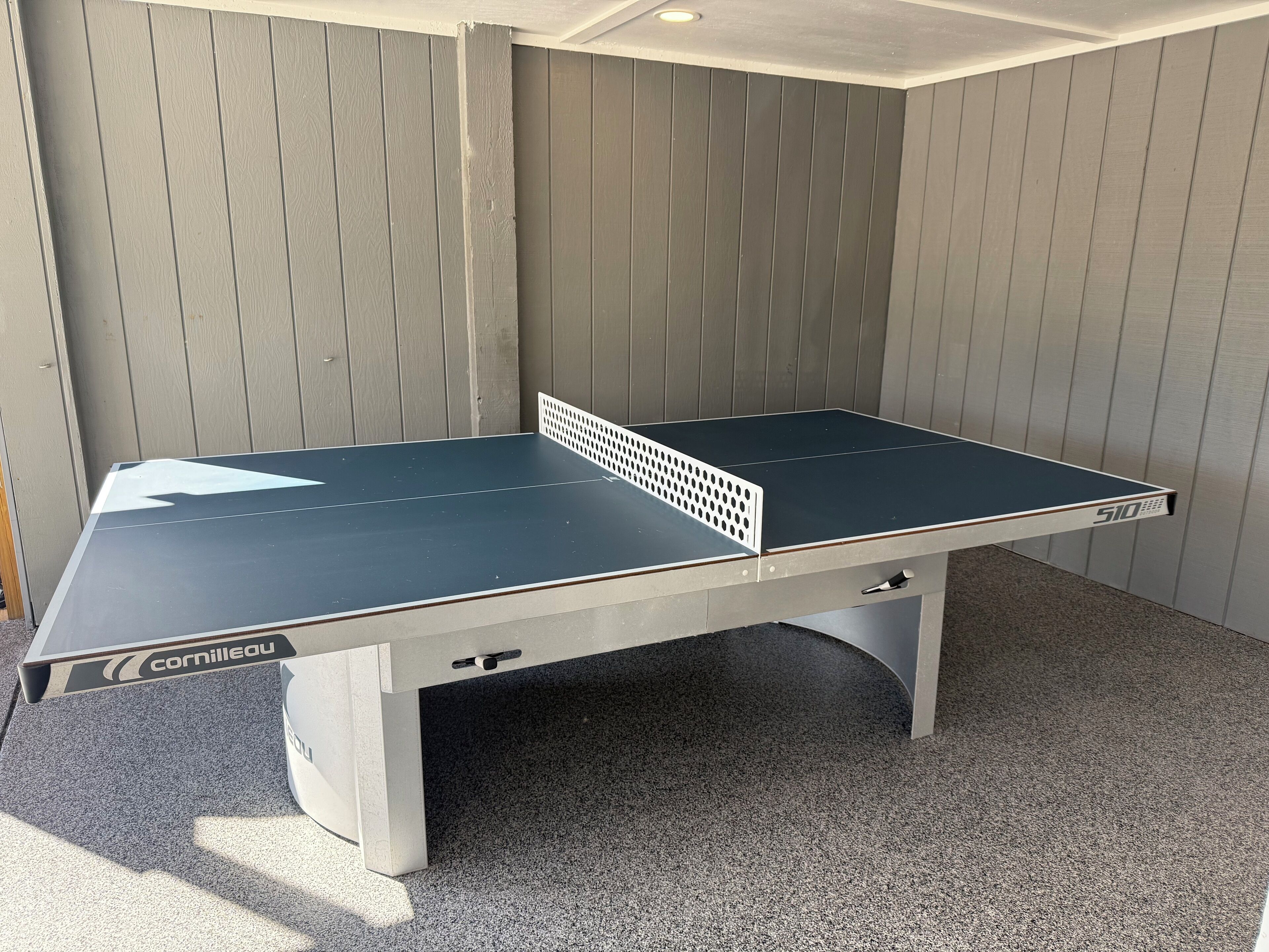 New, modern ping pong table; custom-coated concrete floors