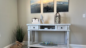 A rustic wooden console table with a decorative tray, a welcome sign, and a lantern. - Your Ultimate  Retreat – Steps from Beach with PVT Heated Pool, Slide & Hot Tub! (Surf City)