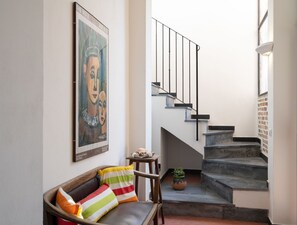 A staircase with a black railing leading to a landing.