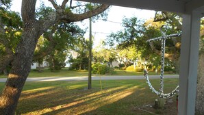 A porch with a view of a street and trees. - Quiet 3 bedroom, 2 Bath Home located within 1/2 mile of ferry to Cape Lookout  (Harkers Island)