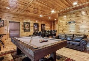 A pool table in a room with wooden walls and a leather couch. - Day Dreamer by Beyond Expectations: Cozy Cabin w/ Views & Outdoor Fun (Gatlinburg)