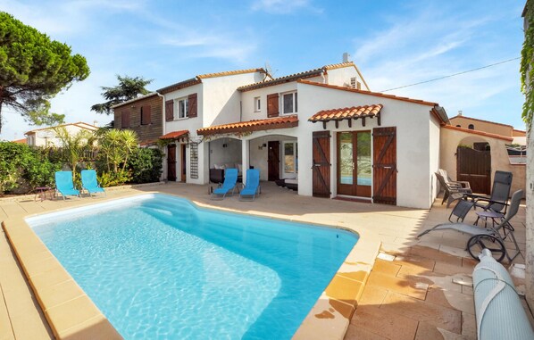 Relax by the outdoor pool surrounded by lounge chairs.