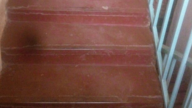 A set of red wooden stairs with metal railings. - Kiuu Guest House (Ruiru)