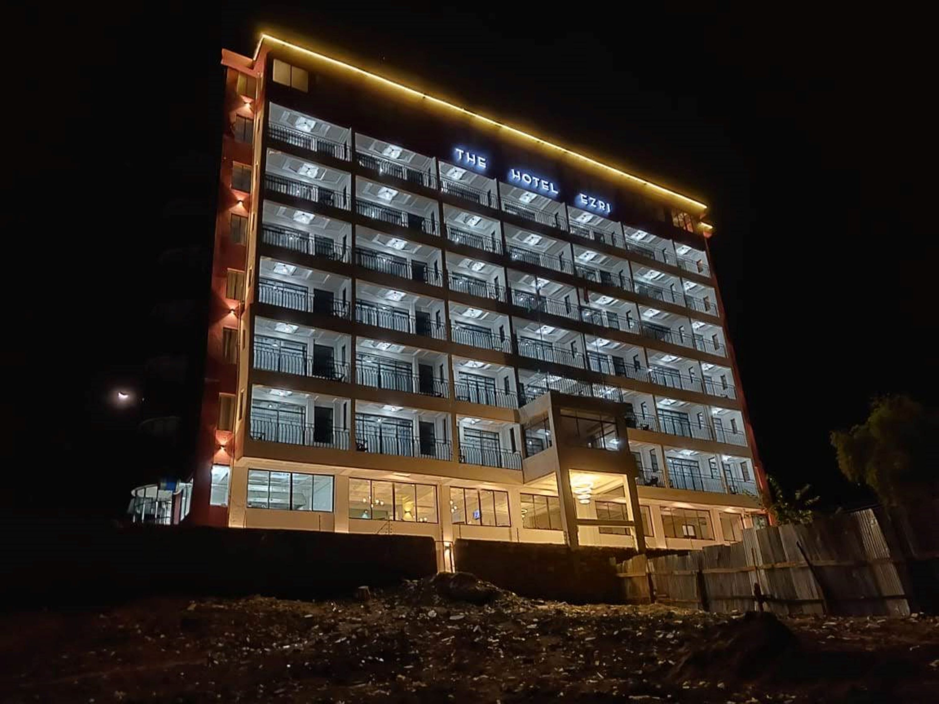 A multi-story hotel with balconies and a sign reading "THE HOTEL CZRI".