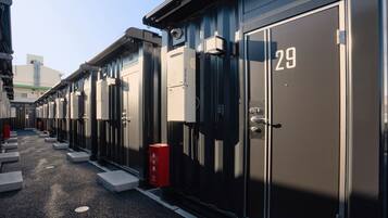 A row of identical metal lockers with numbers on them, likely for storage or security purposes.