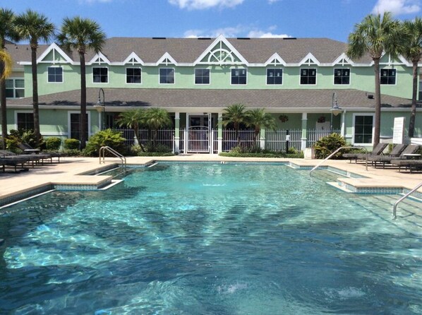 A pool area with a building in the background.